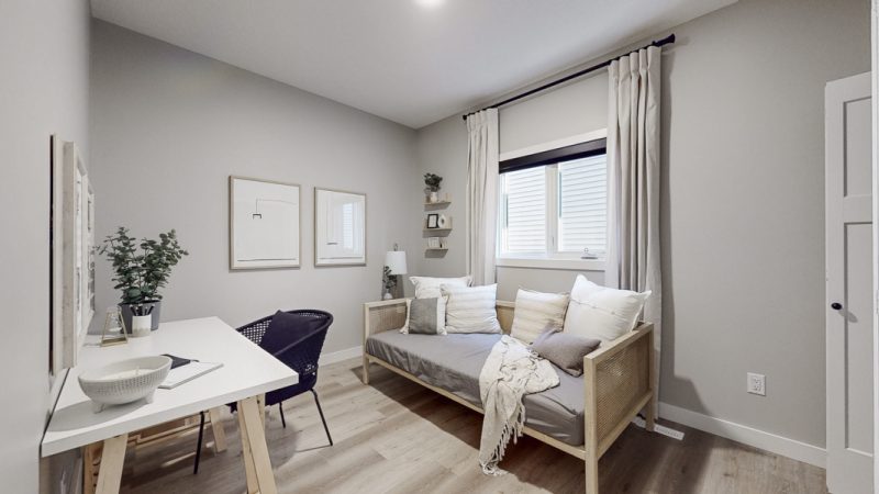Main floor bedroom in Sterling Home's Atlas Showhome in Kinglet by Big Lake